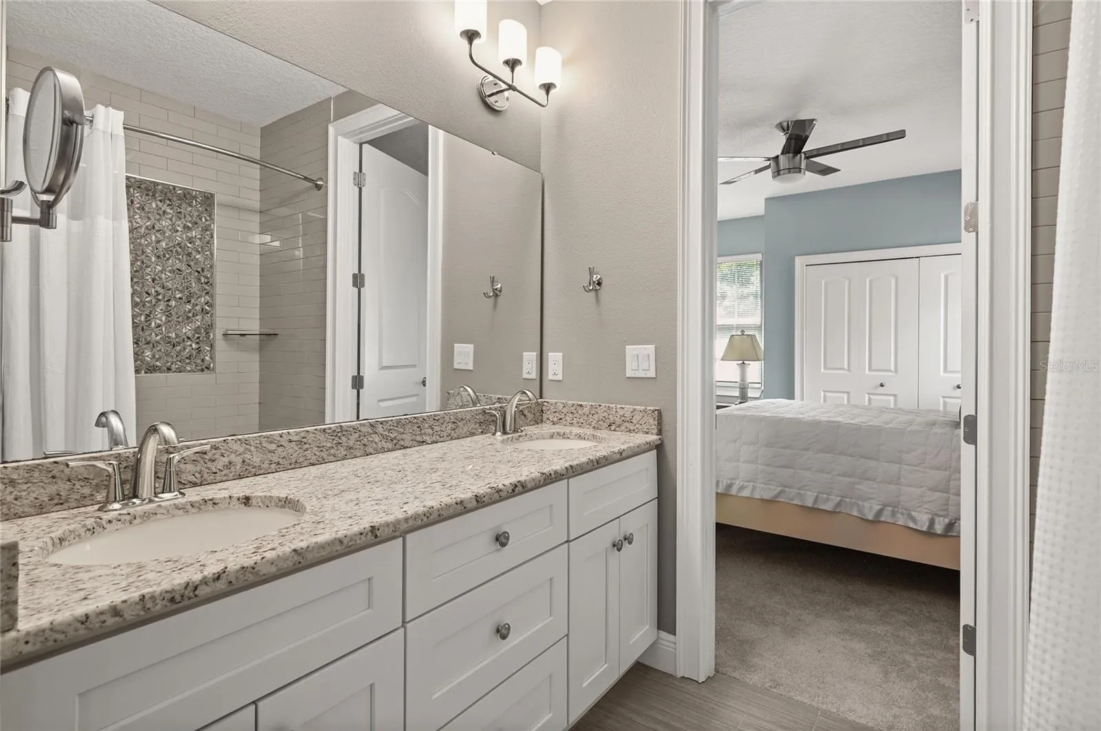 The bathroom features double sinks and a linen storage closet.