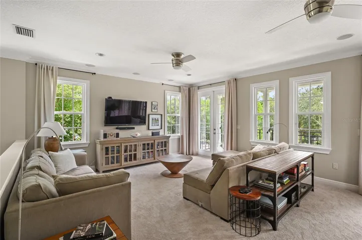 Double french doors let the light in and show off the surrounding tree canopy.