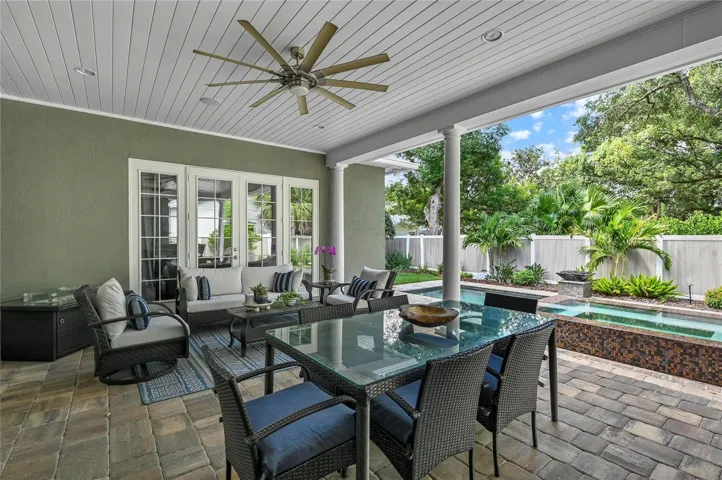 Meals at the outdoor table come with a show-stopping view to the private backyard oasis.