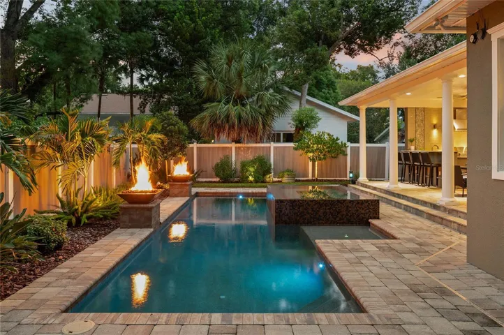 Lovely pavers flow from the patio to the deck for a finished look.