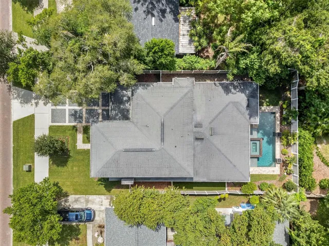 The home is surrounded by lush, mature trees.