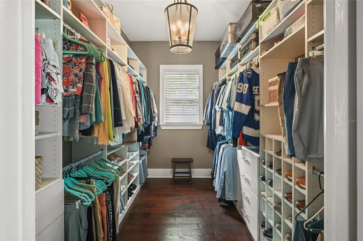 Another space made large by the natural light, high ceilings, and organizers, the primary closet checks all the boxes.