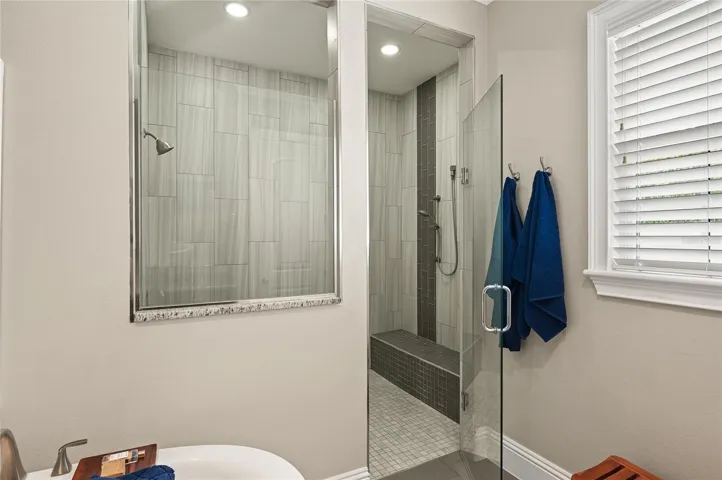 The oversized shower was thoughtfully designed with a handy bench seat and controls located just inside the shower opening.