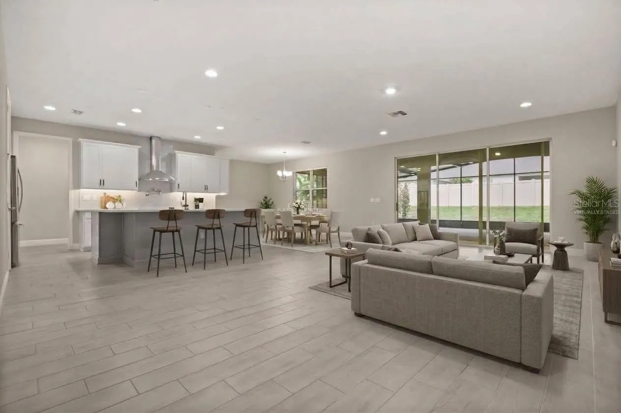 Open floor plan with triple slider leading to back Lanai virtually staged