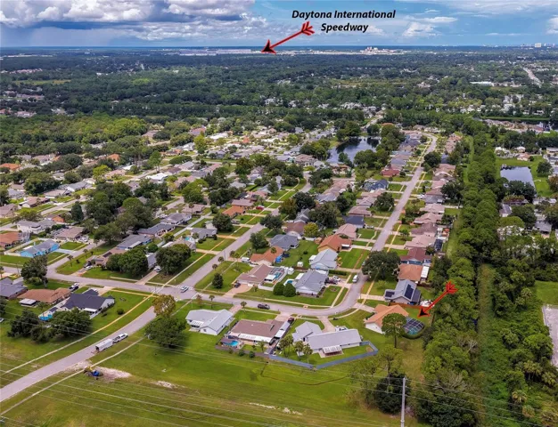 Broad aerial view pointing out the regional location relative to Daytona International Speedway and surrounding residential sectors.