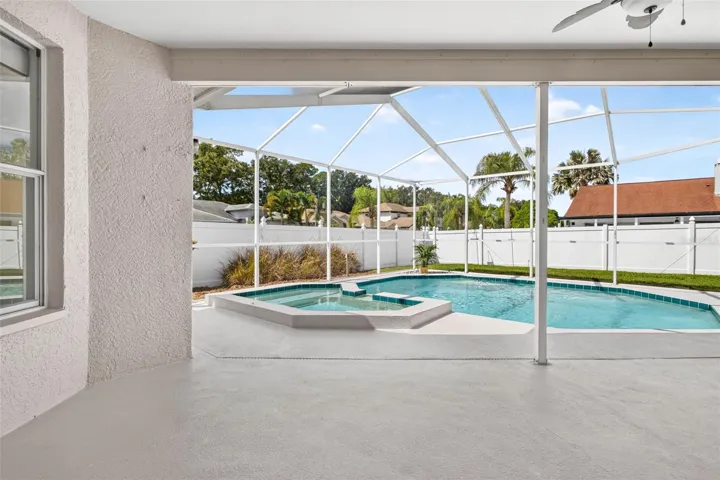 Screened pool lanai and room to play in the fenced backyard
