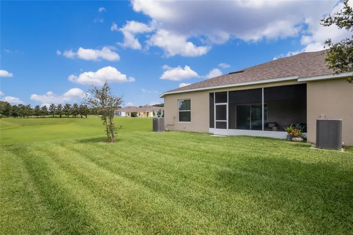 Back of home. No neighbors on side and view of golf course and sunset views.