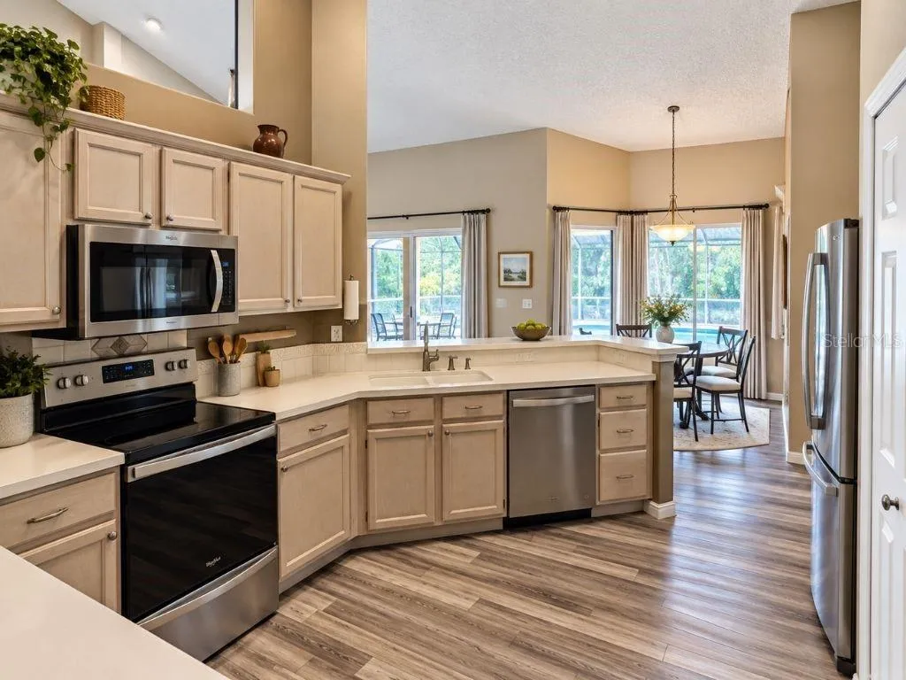 Spacious kitchen with breakfast bar and views toward the pool