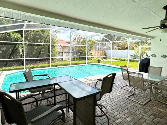 Screened-in pool with covered outdoor living area