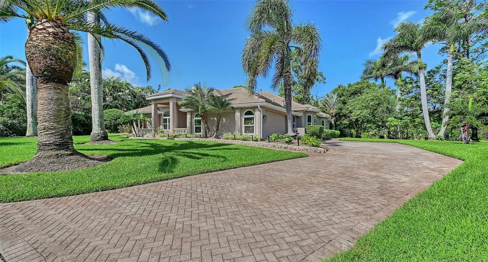 Long paver driveway with the side entry two-car garage.