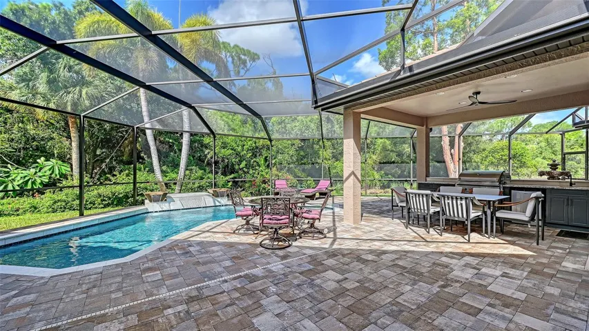 Screened pool area with gazebo and summer Kitchen.