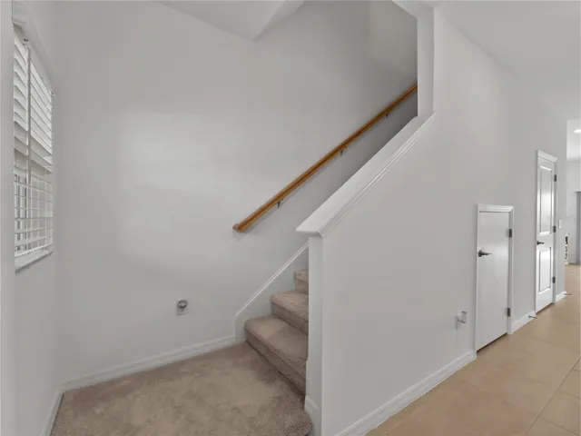 Stairs leading upstairs to 3 bedrooms and 2 full bathrooms