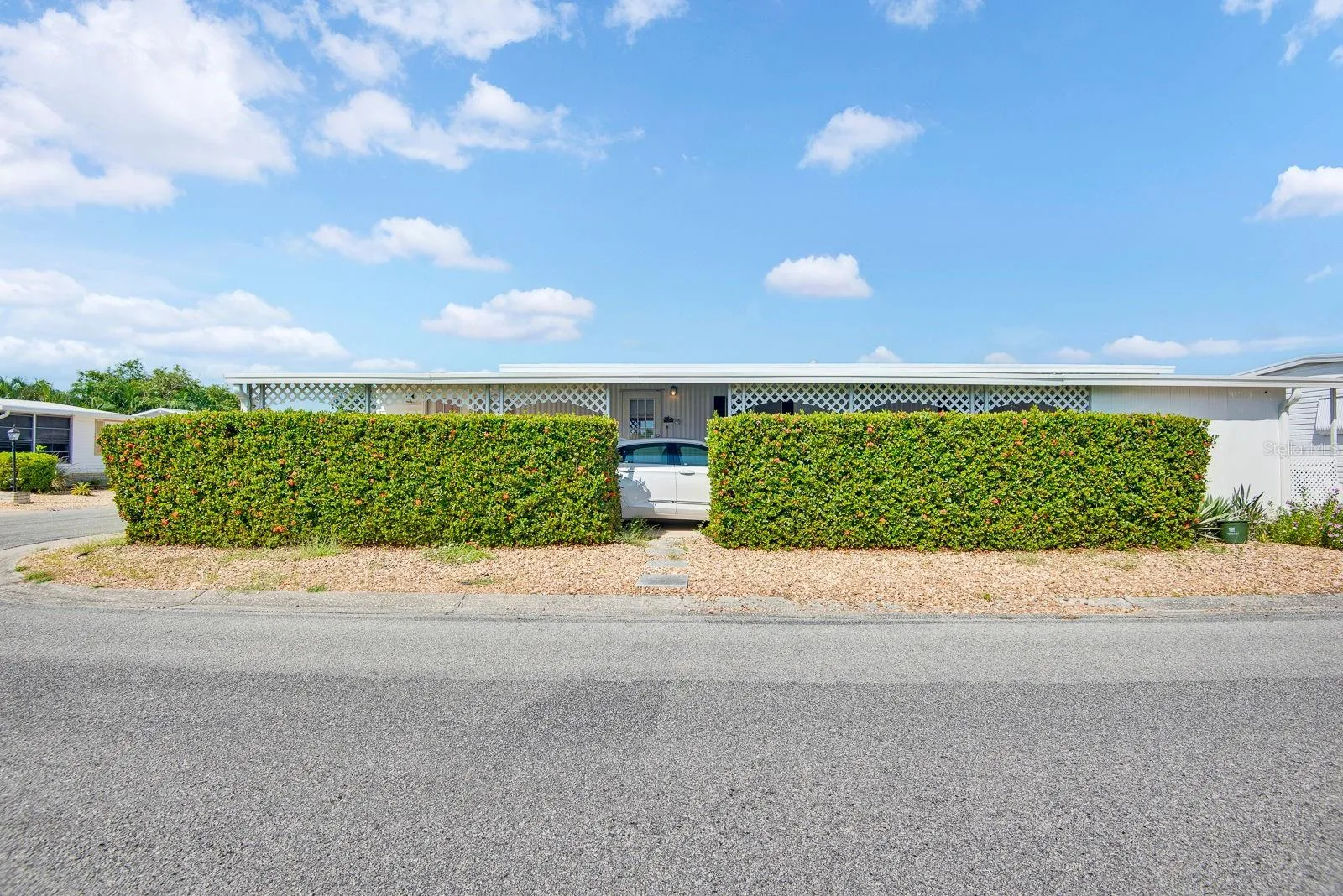 Side View from Clubhouse facing the home, large corner lot