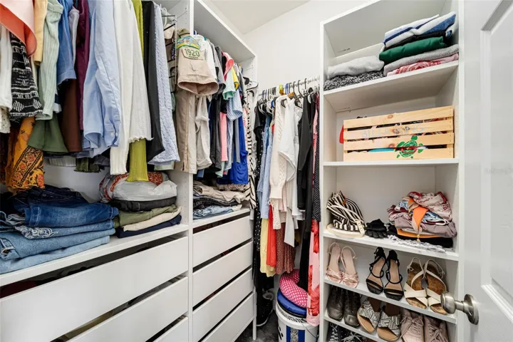 Large walk-in closet with plenty of storage.