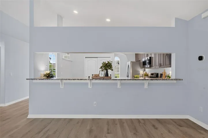 Vacant family room with kitchen breakfast bar view