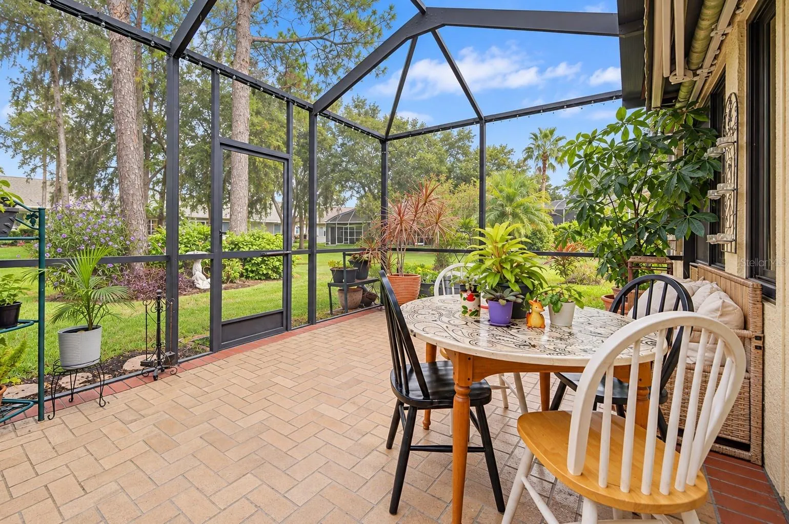 Screened in brick lanai is a great place to start or end your day