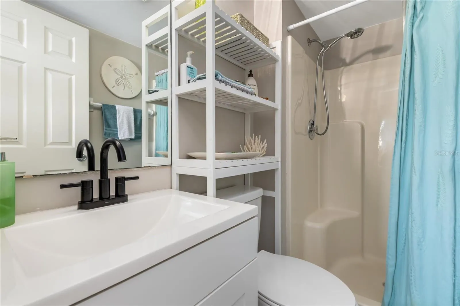 PRIMARY WALK IN SHOWER SOLID SURFACE COUNTER.