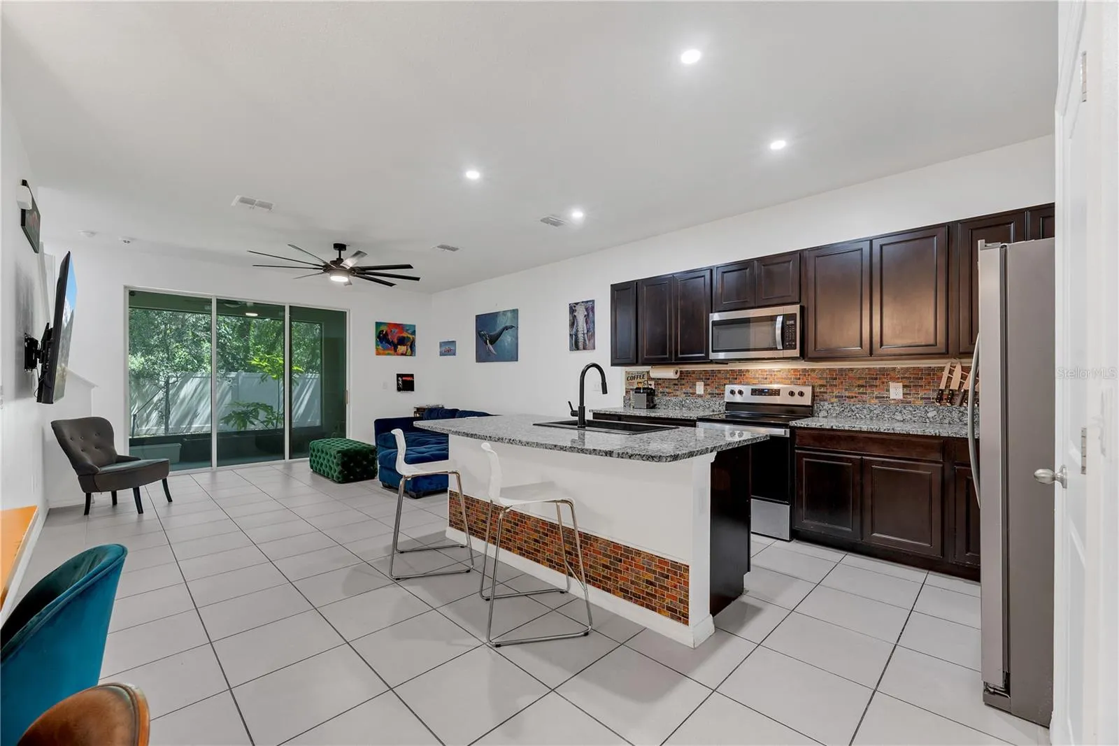 Step through the sliding doors to the covered and screened porch.