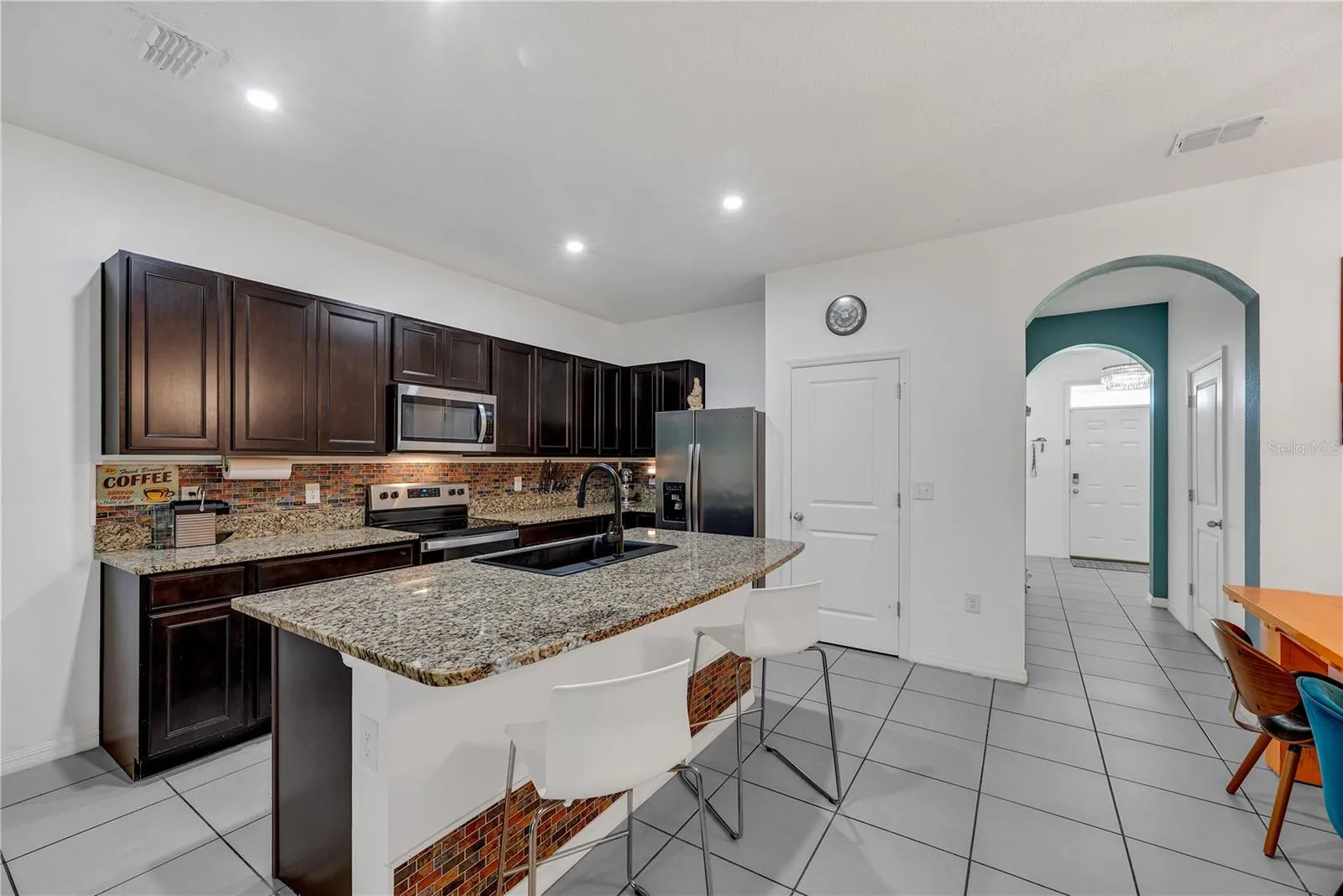 The spacious kitchen island is ideal for meal prep and entertaining, with a thoughtfully designed work triangle that makes cooking and cleanup easy and efficient.