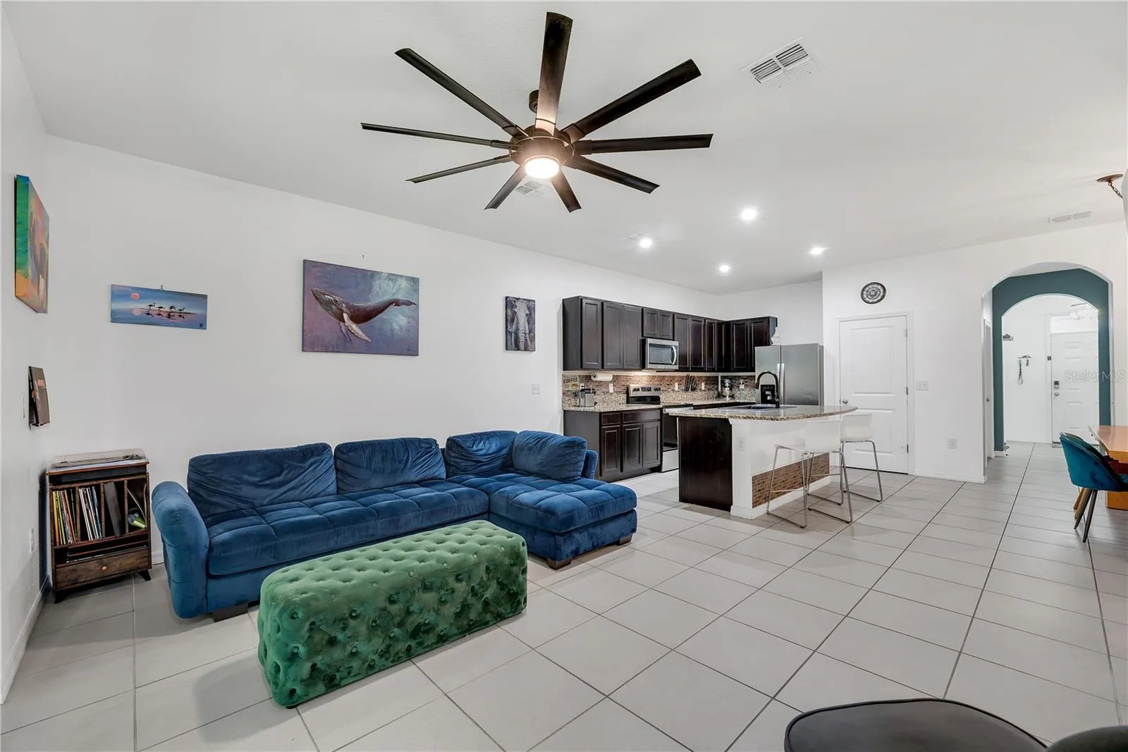The kitchen seamlessly connects to the living area, creating an inviting space where you can easily prepare meals, entertain guests, or relax with family.