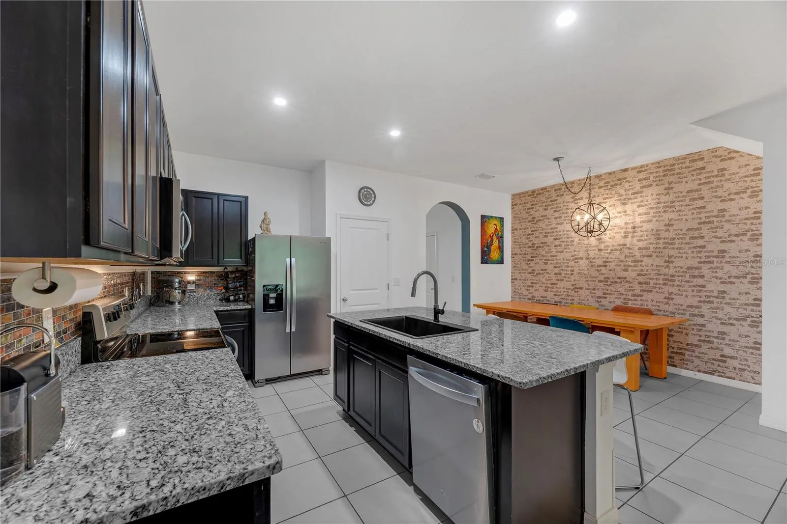 There is a spacious walk-in kitchen pantry to store all of your kitchen essentials and a dining room area with room for a large table.