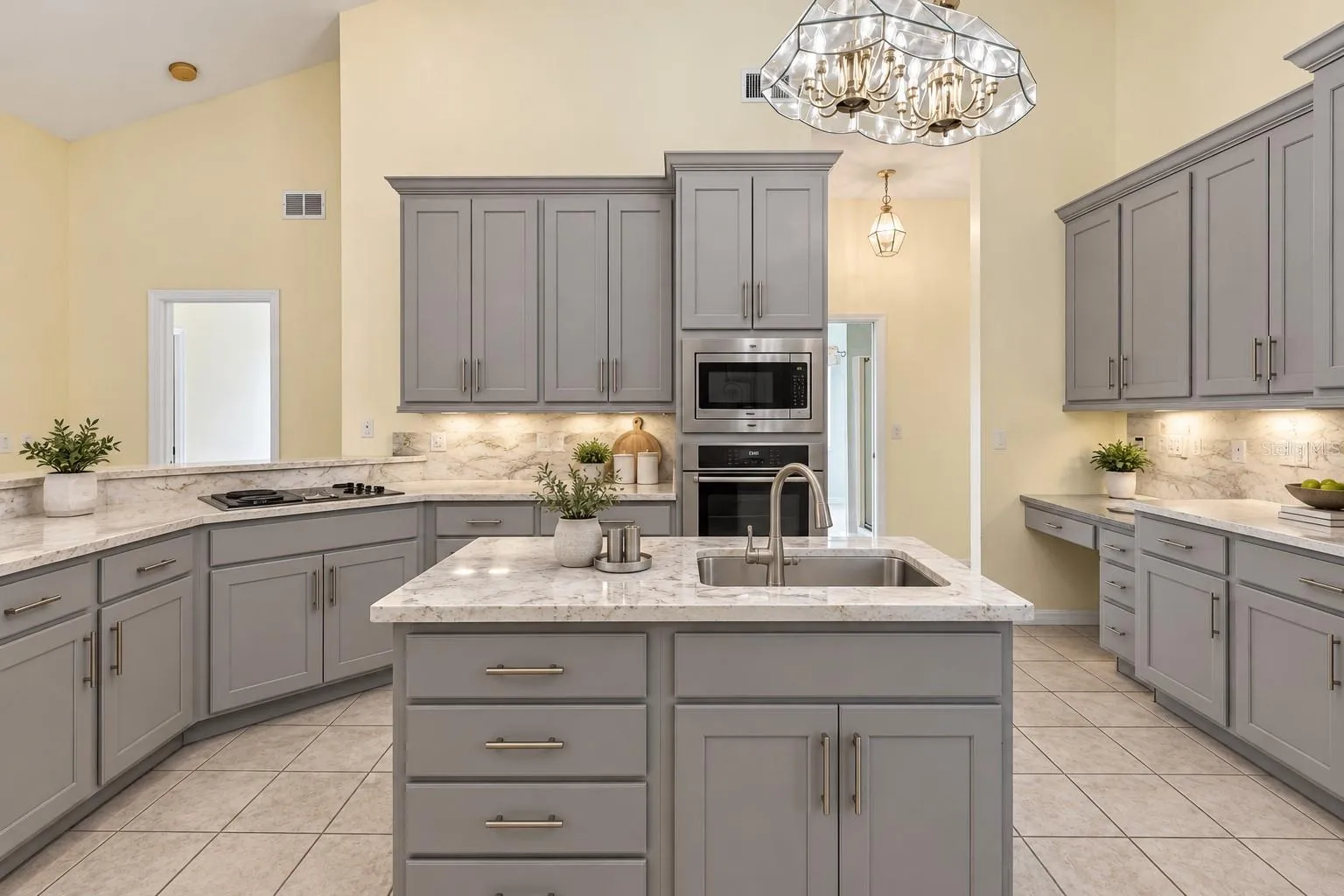 Virtually Changed to show remodel with new counters and painted existing cabinets.