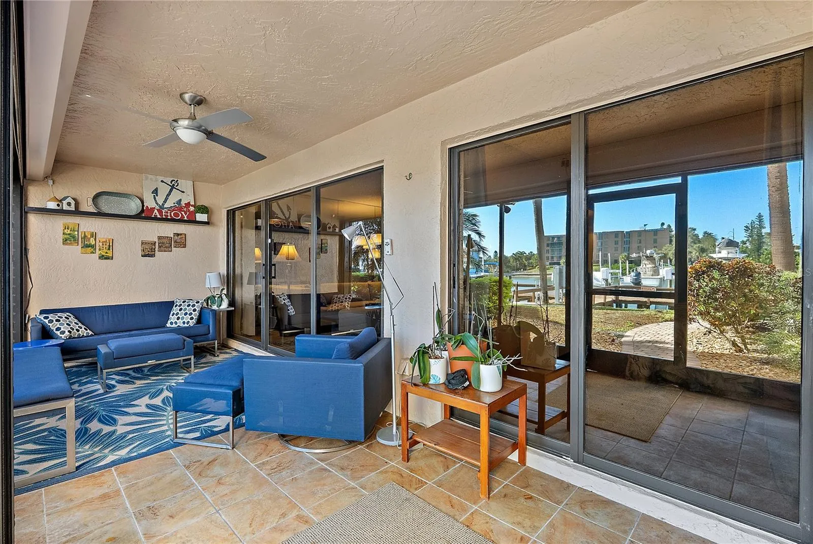 Expansive patio with living area and primary bedroom access. Hurricane shutters on the outer screen.