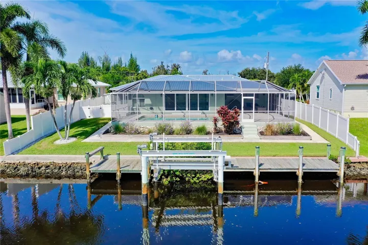 Exterior of the home showing private dock and boat lift.