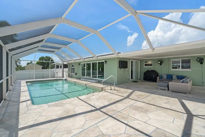 Pool area with large uncovered lanai space.