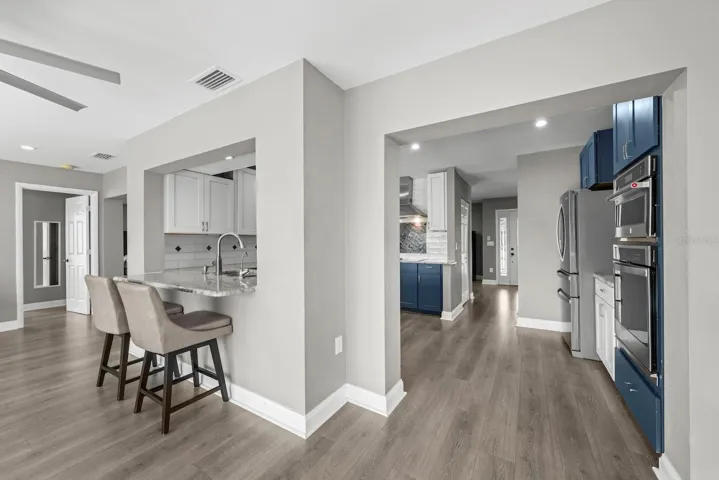 Kitchen cont. with pass through area for barstools.