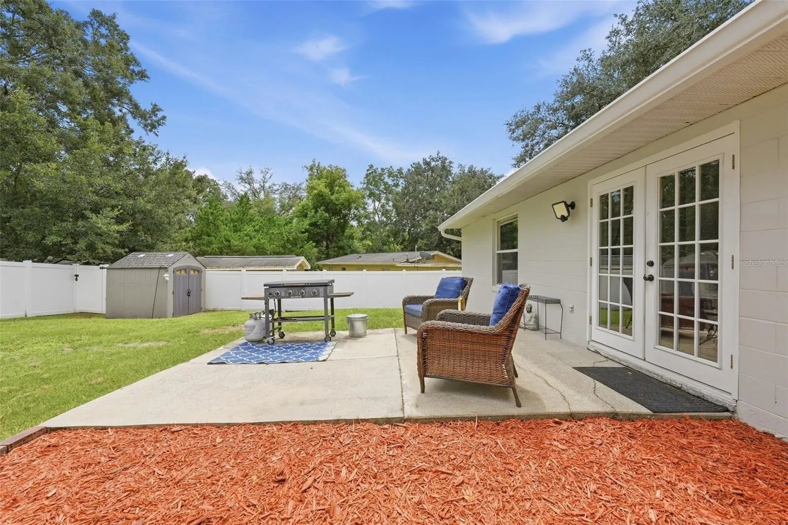 Large yard with concrete pad for grilling!