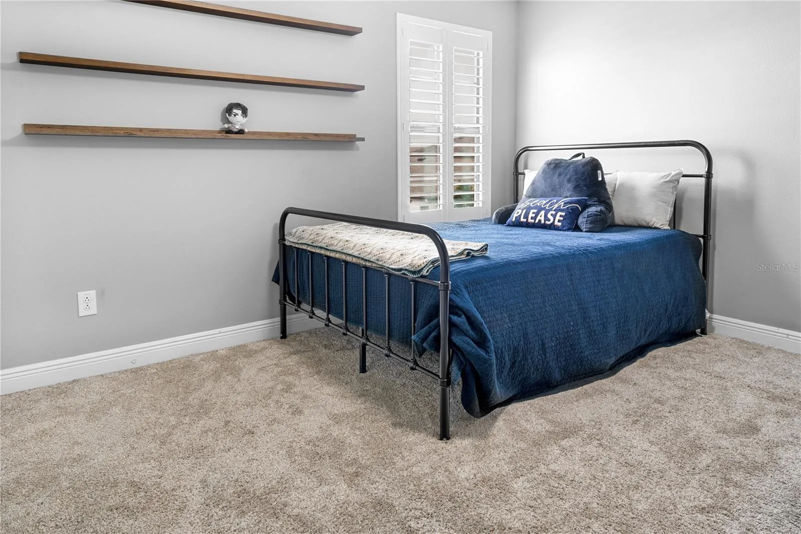 secondary bedrooom  upstairs with accent shelves