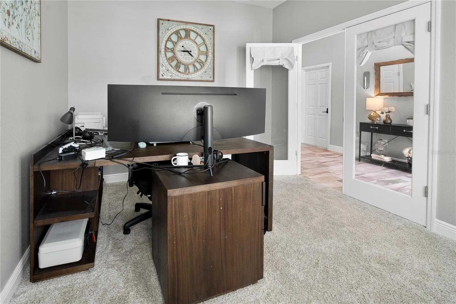 Flex room off foyer set up as home office with double door entry