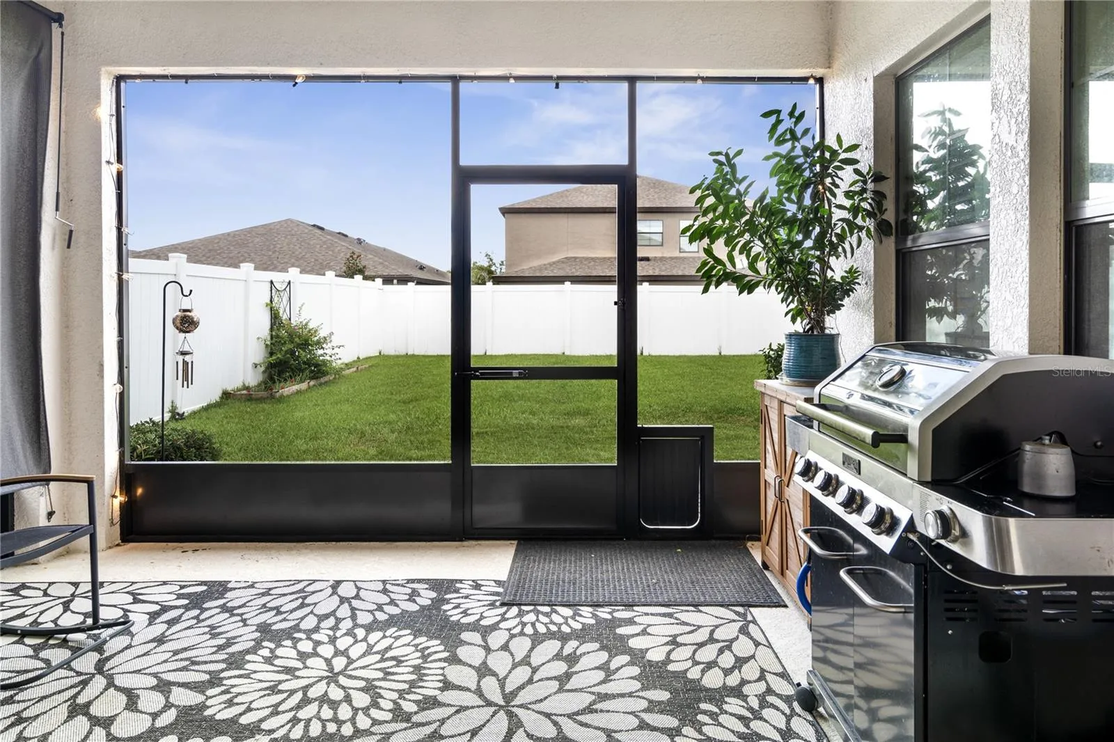 Screened back porch overlooks the fenced backyard for privacy!