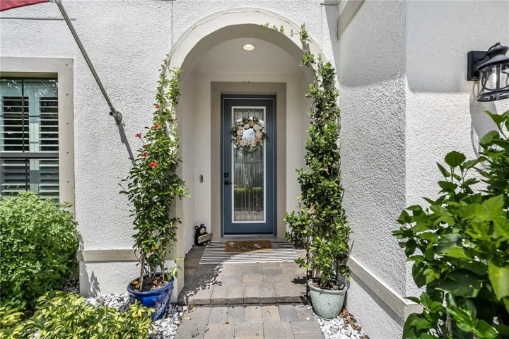 Arched entry with leaded glass door welcomes guests