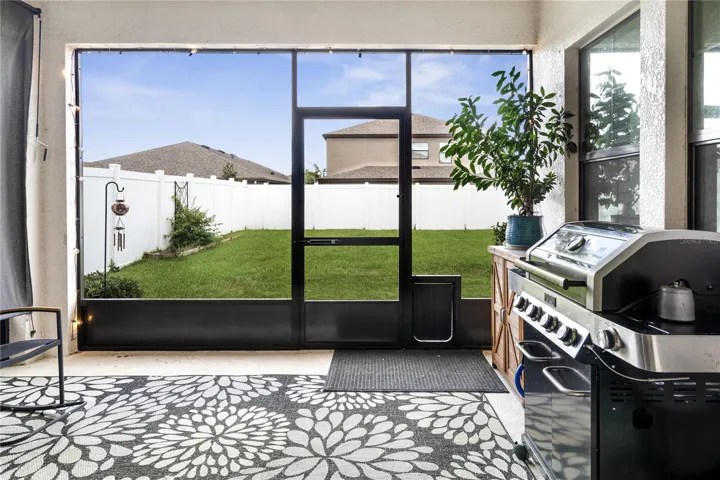 Screened back porch overlooks the fenced backyard for privacy!