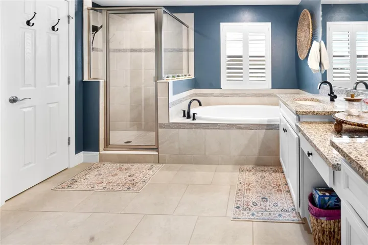 Bath ensuite in owners retreat boasts separate shower, soaking tub and stunning floors!