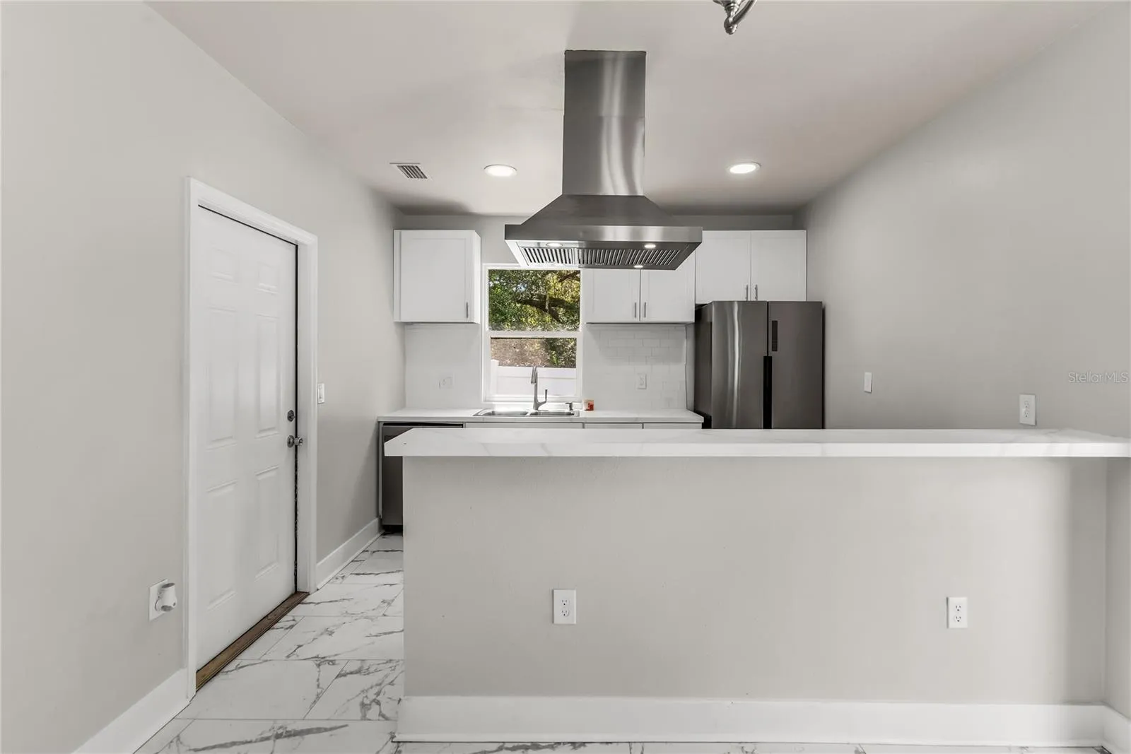 Kitchen features granite countertops, modern subway tile backsplash and stainless steel appliances.