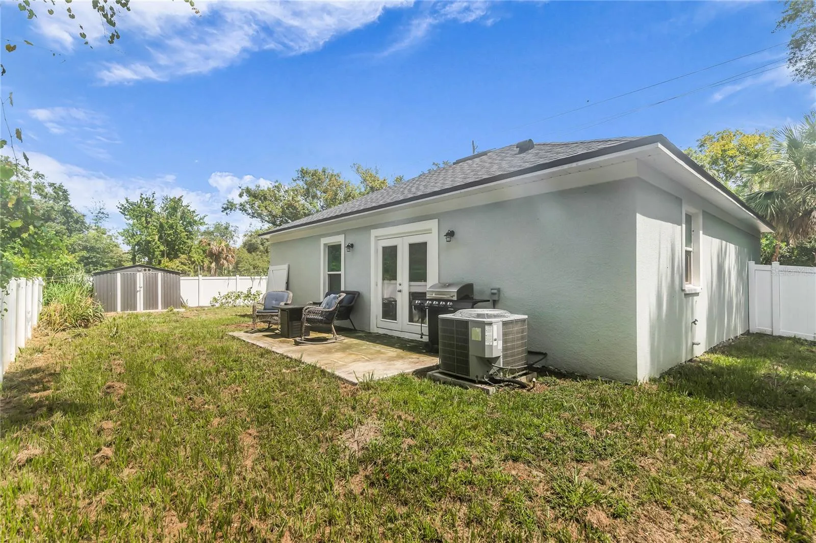 Fully fenced in back yard with storage shed