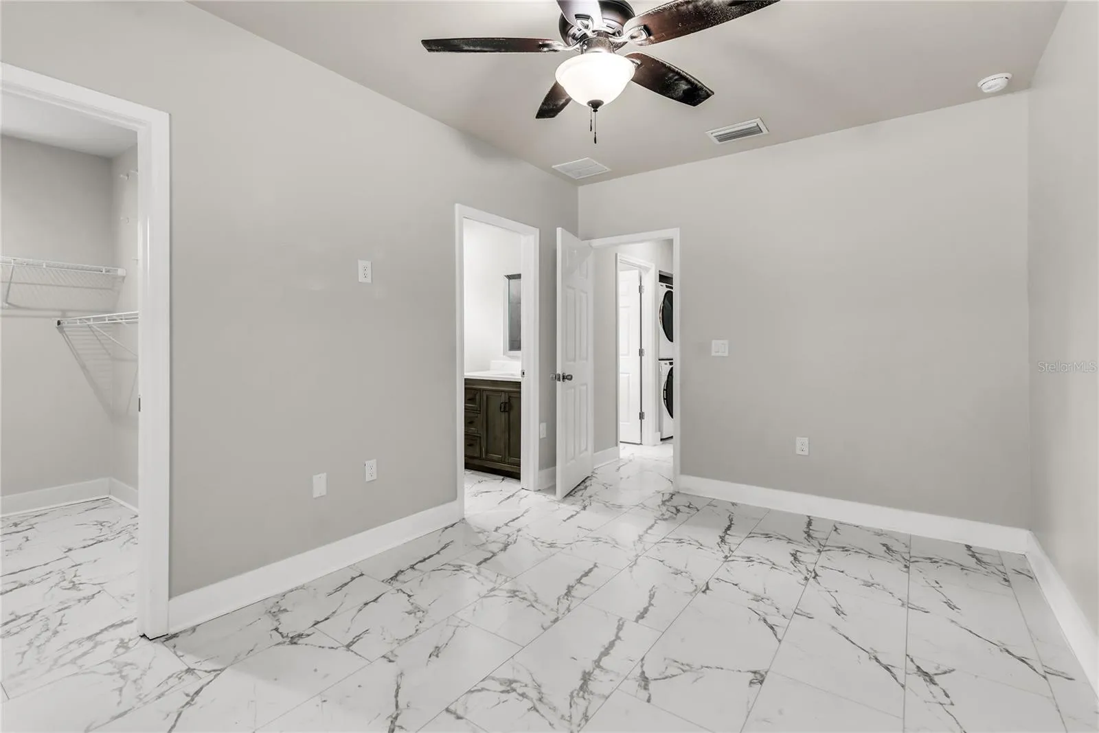 Primary bedroom with walk-in closet and ensuite bath