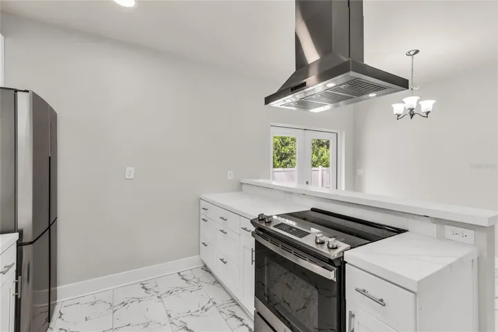 Kitchen features granite countertops, modern subway tile backsplash and stainless steel appliances.