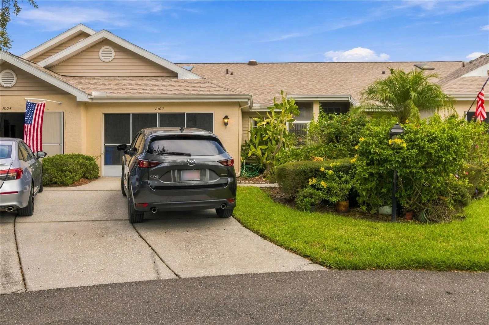 Welcoming front entry with ample space for a car and golf cart in the garage