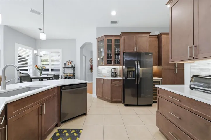 Custom glass front cabinets and built-in wine fridge