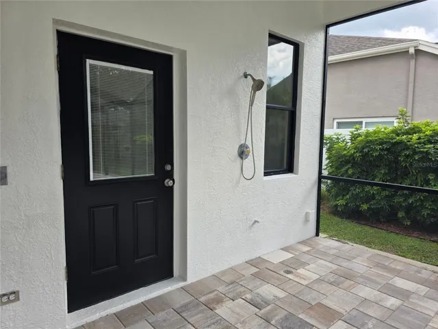 Pool door from primary bath with outdoor shower