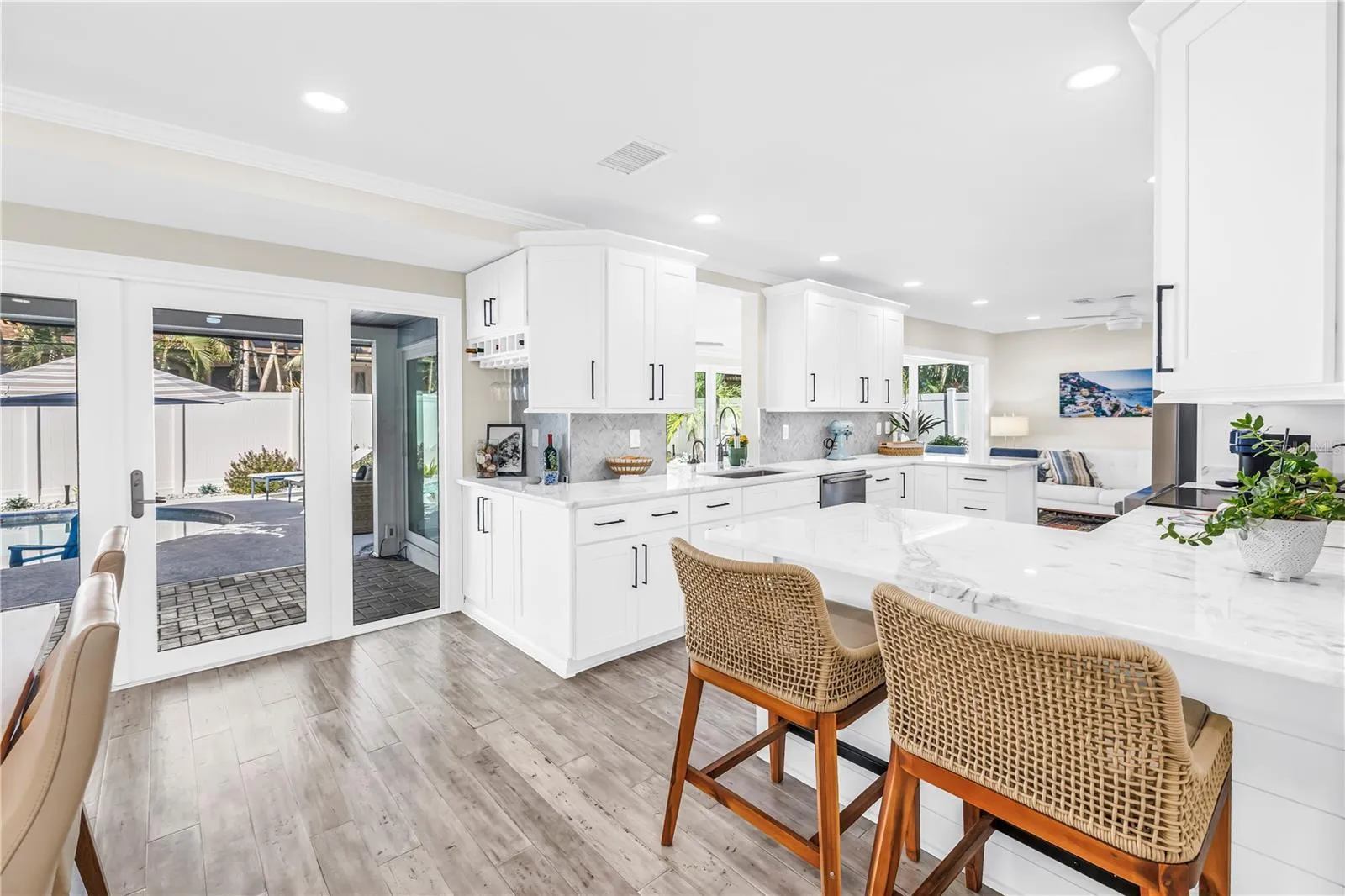 Casual seating to "help" the cook in this Showstopper Kitchen! Quartz countertops have a very light blue hue!