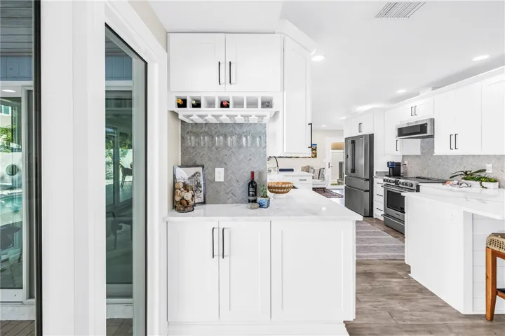 Custom built-in bar area with herringbone tile backsplash.