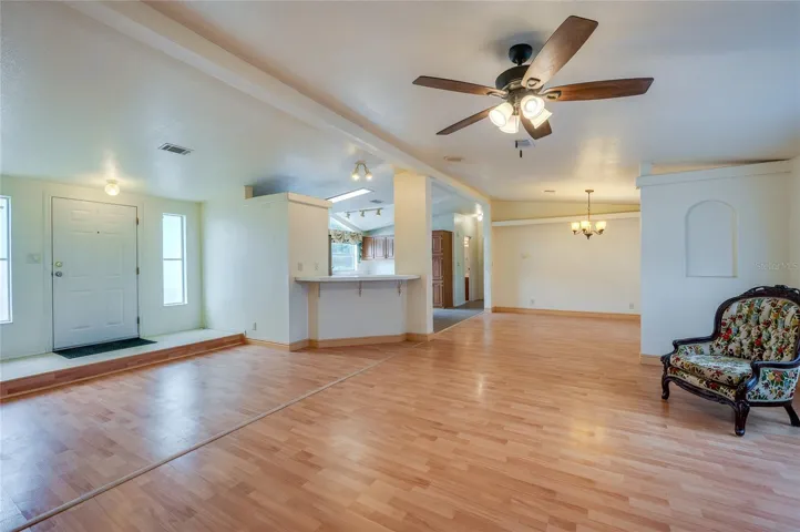 An expansive main living space connects the living room, dining area, and kitchen, creating a versatile layout for everyday living and entertaining.