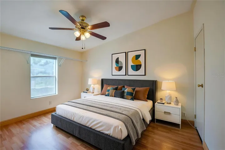 Virtually Staged...Bright bedroom features a ceiling fan, window for natural light, and ample open space for flexible furniture placement.