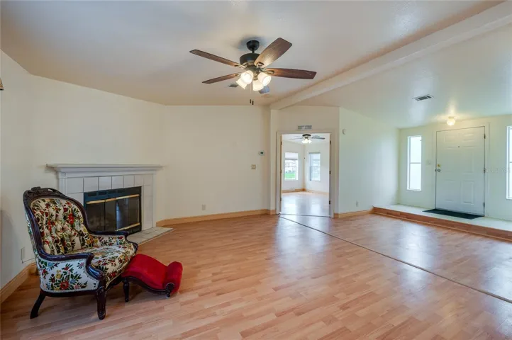 This angle showcases the home's open interior flow, with the fireplace anchoring the living room and the raised entry positioned just beyond.
