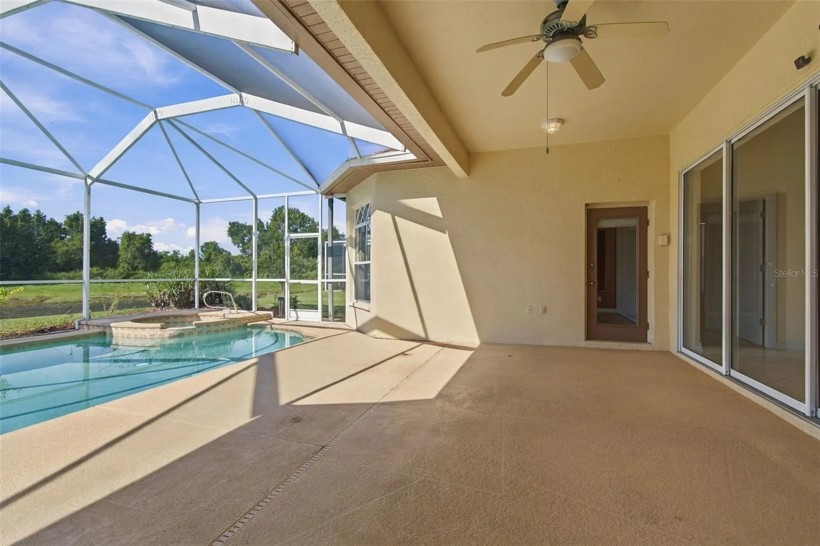 Your screened lanai features three access entries from the home.  The primary bedroom and secondary  bathr offers access doors.  The family room offers a double sliding glass door.